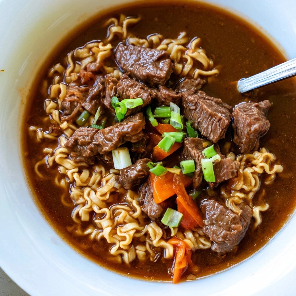 Close-up of comforting One-Pot Beef Ramen; steam rising from a delicious, easy weeknight meal.