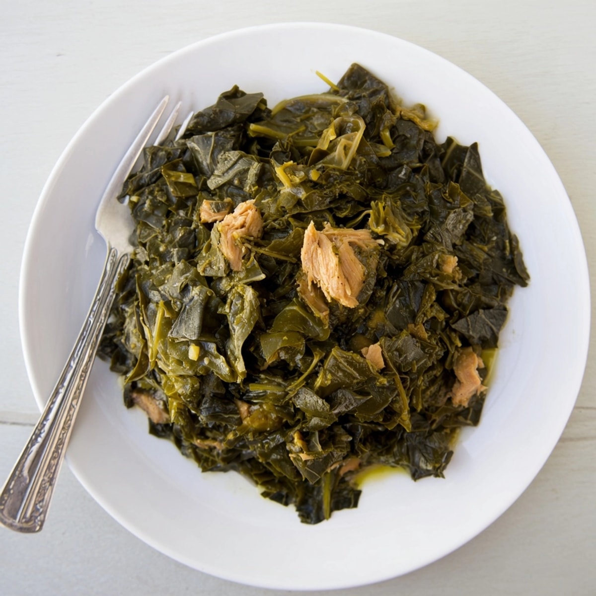 Smoky collard greens with smoked turkey, simmered to tender perfection, ready to serve.