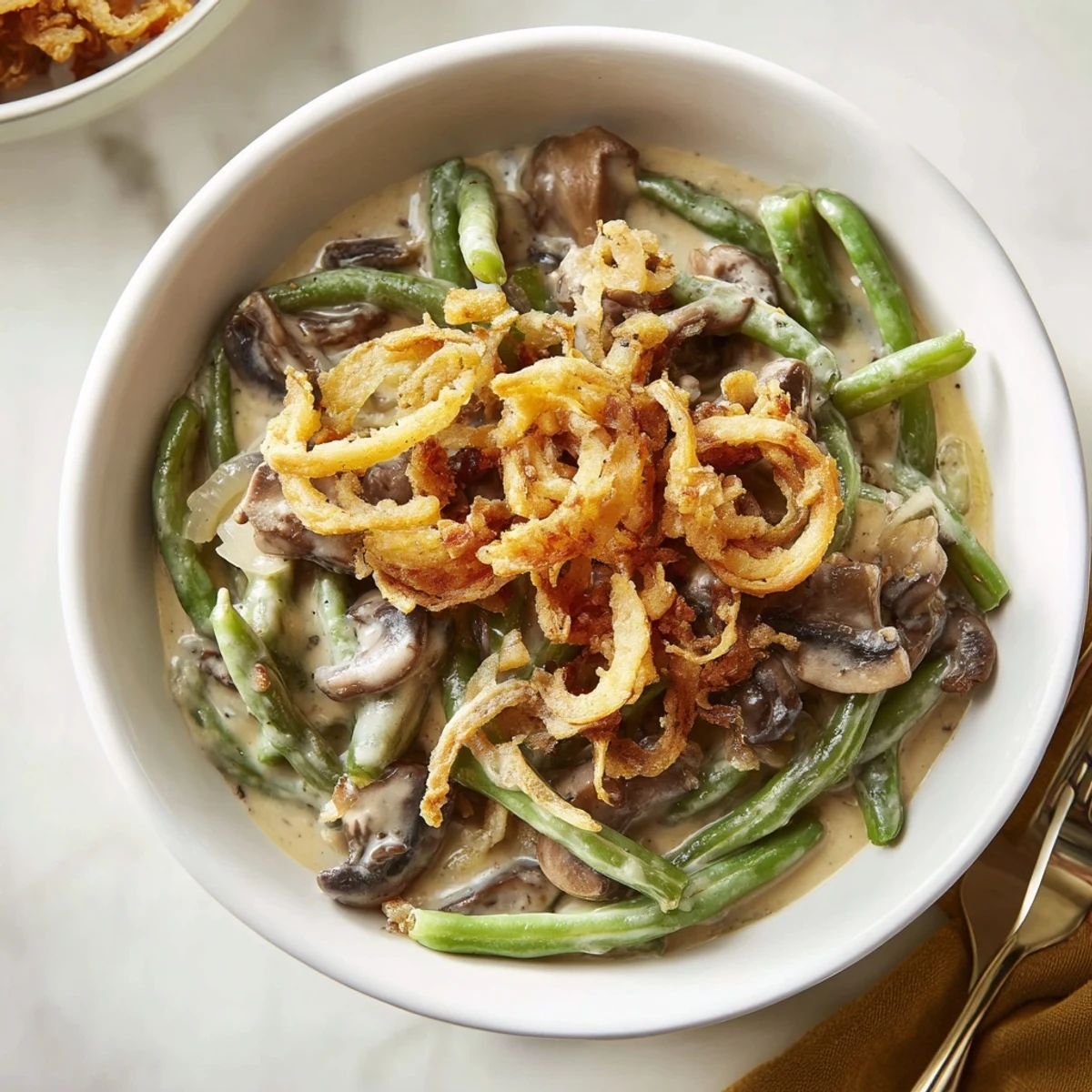 Delicious old-school green bean casserole with crunchy onions, perfect for family feasts.
