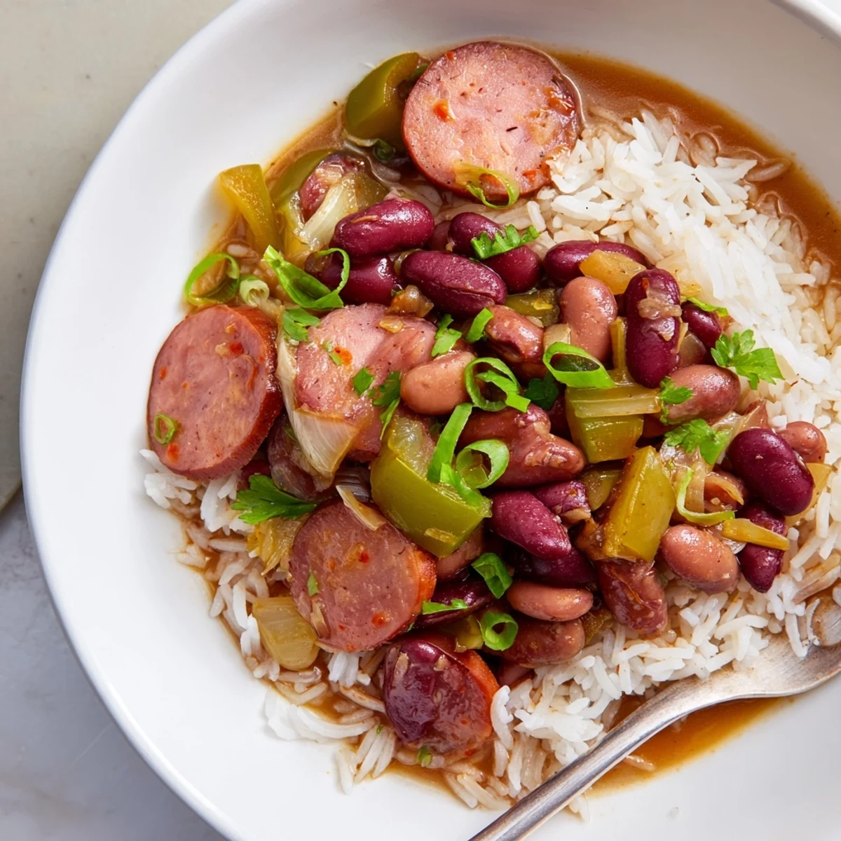 Hearty Red Beans & Rice topped with green onions and served steaming hot.  