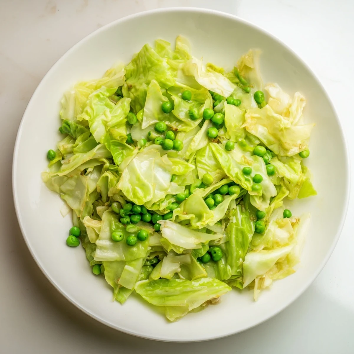 Savory Garlic, Soy, makes this Cabbage Stir-Fry delicious with bright green peas and tender cabbage.