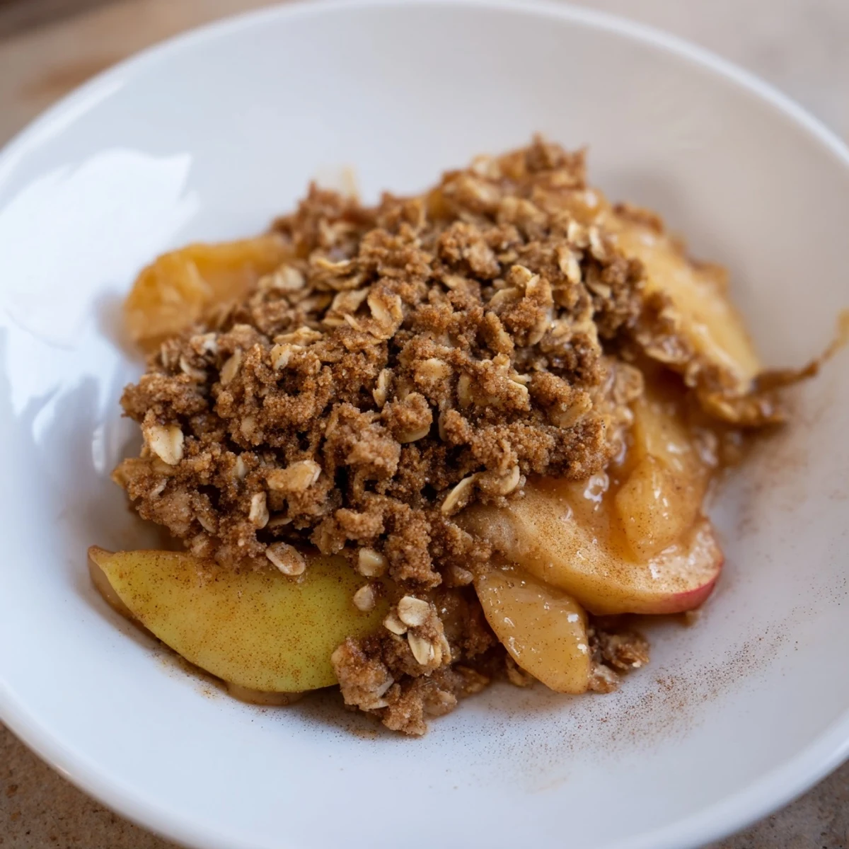 A close-up shot of freshly baked Apple Crisp, highlighting the golden, crisp topping and juicy apples.