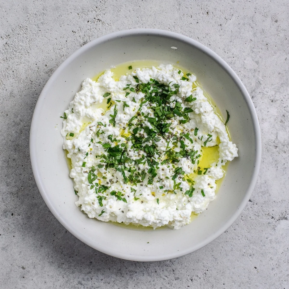 Delightful Mediterranean appetizer: A bowl of whipped feta, drizzled with lemon-mint and ready to serve.