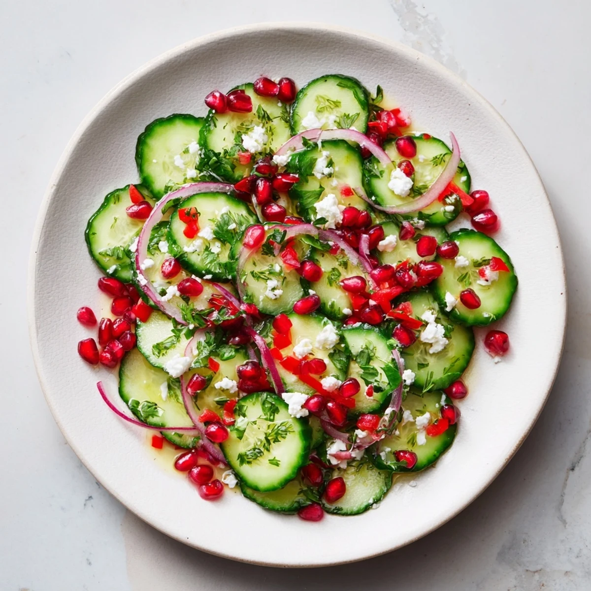 A vibrant Healthy Cucumber Christmas Salad with crisp cucumber and ruby pomegranate seeds.