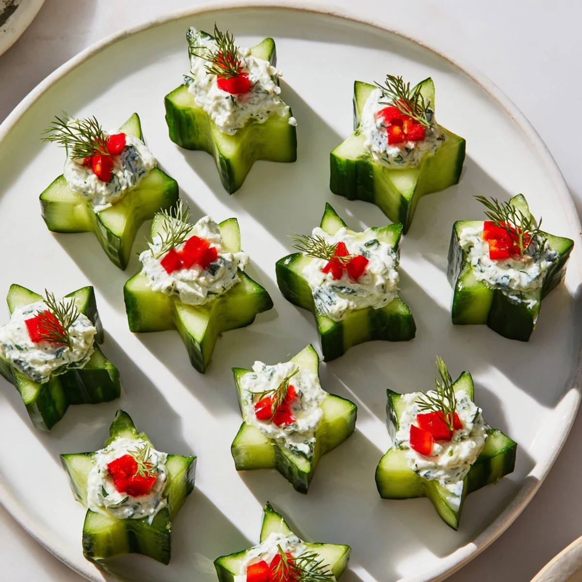 Festive Cucumber and Dill Christmas Stars appetizer, with vibrant cucumber stars featuring creamy cheese and fresh dill.