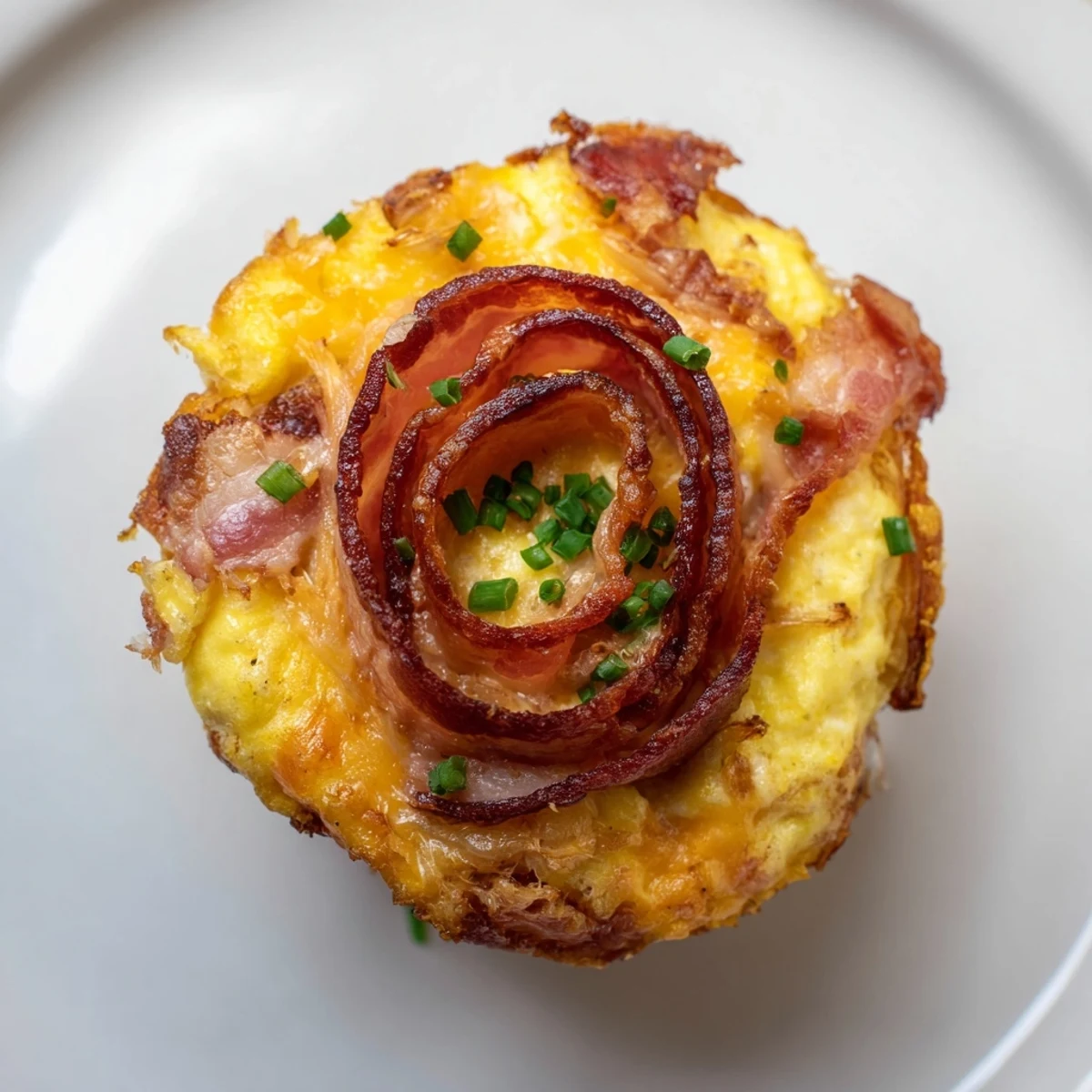 Savory scrambled egg cups with crispy bacon, a delightful American brunch or breakfast side.