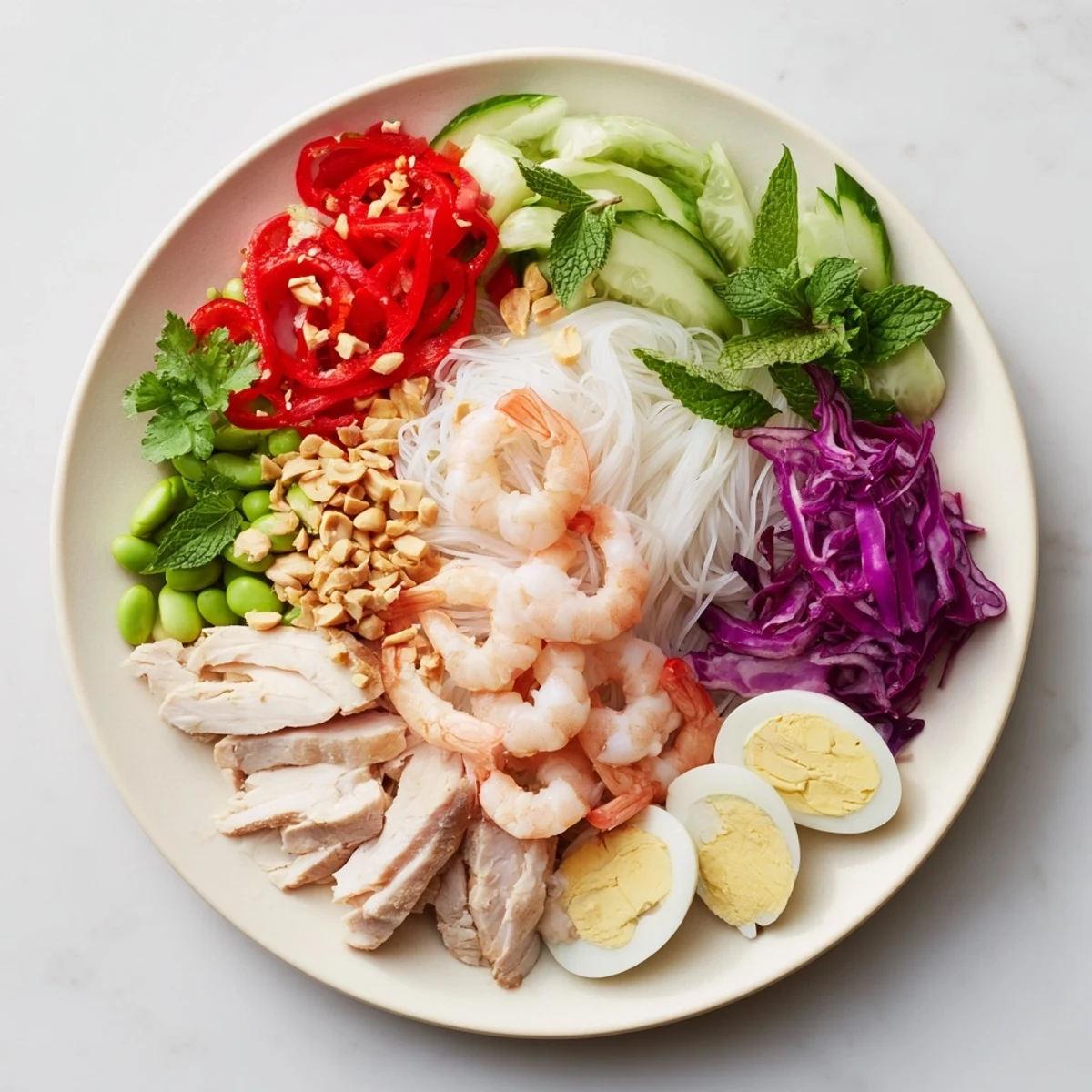 Vibrant Asian fusion noodle bowl featuring colorful vegetables, proteins, and dipping sauces displayed beautifully.