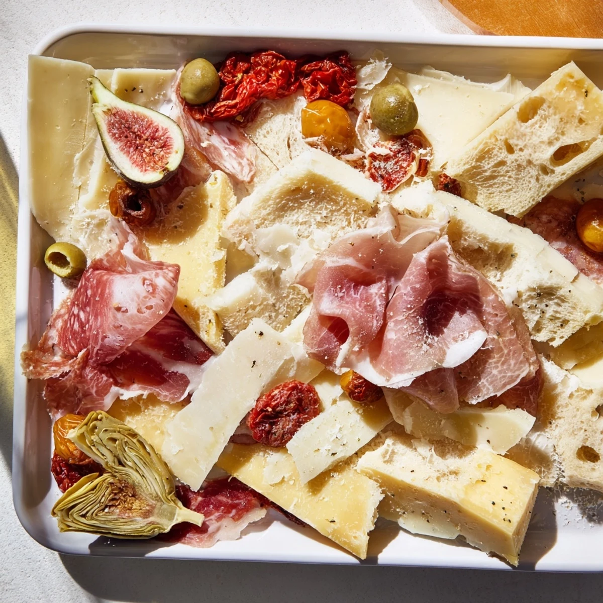 Rustic Italian Farmhouse Board displays a tempting array of cheeses, meats, and olives, a feast for any gathering.