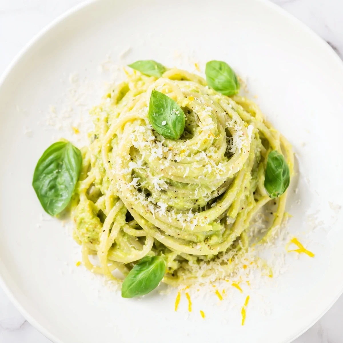 Bright bowl of creamy avocado pasta with Parmesan, ready to serve for a light Italian dinner.