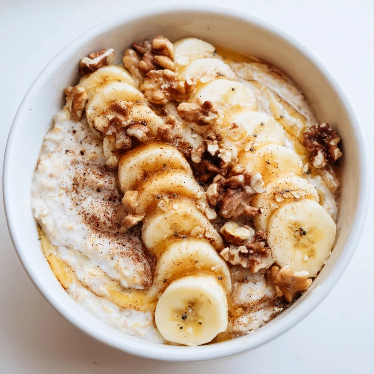 Creamy microwave banana oats, garnished with banana slices, ready for a warm and quick breakfast.