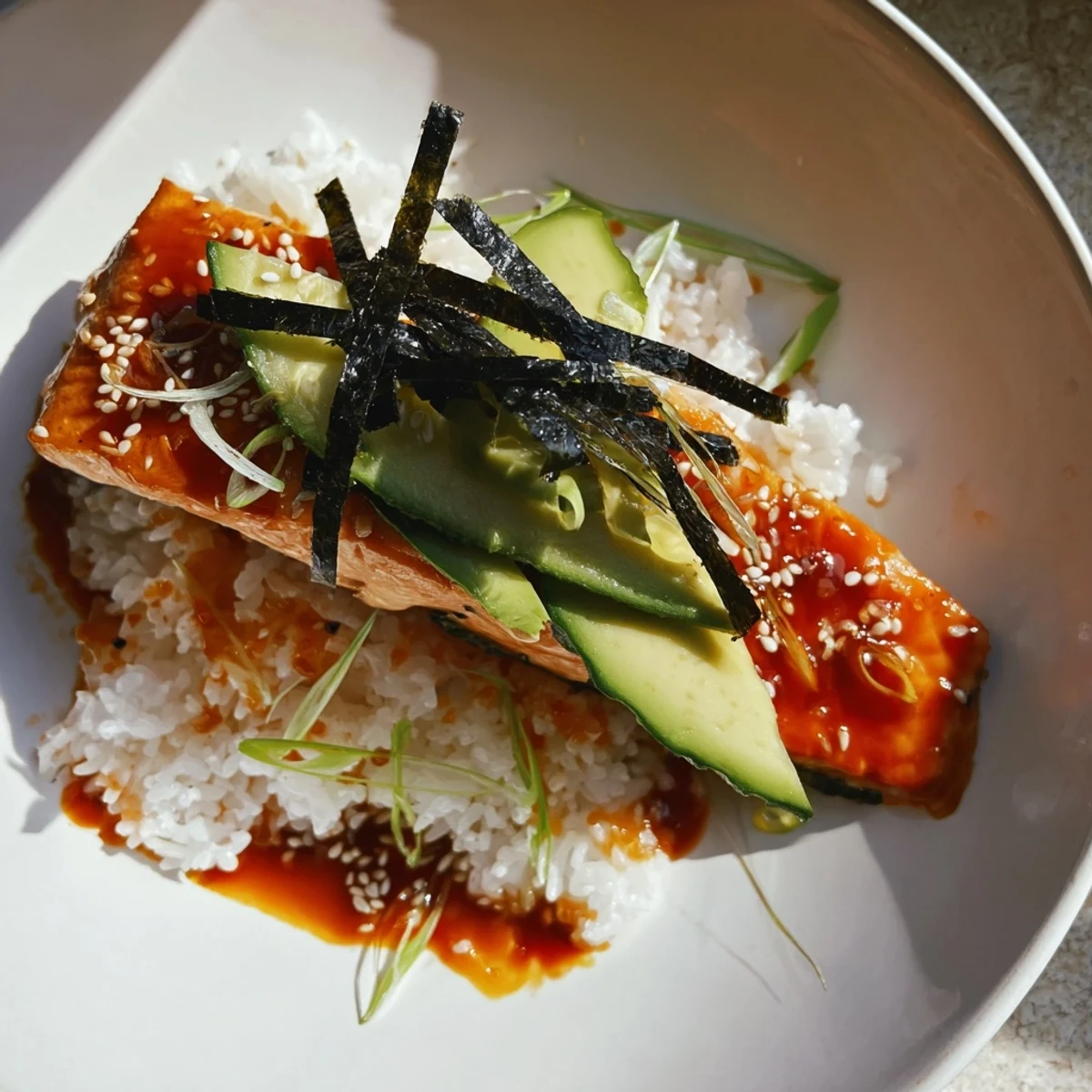 Emily Mariko-Inspired Sticky Orange Gochujang Salmon Bowl with glistening orange glaze and vibrant toppings.