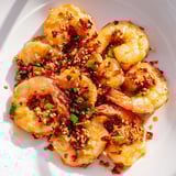 A beautiful close-up of the finished Korean Garlic Butter Shrimp, garnished with scallions and sesame seeds.