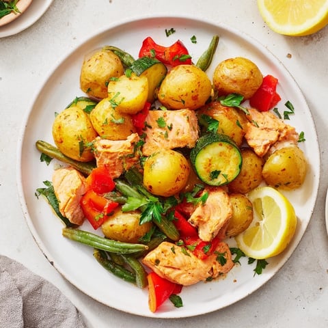 Golden potatoes and flaky salmon pieces in a delicious Salmon & Potato Skillet recipe, ready to eat.