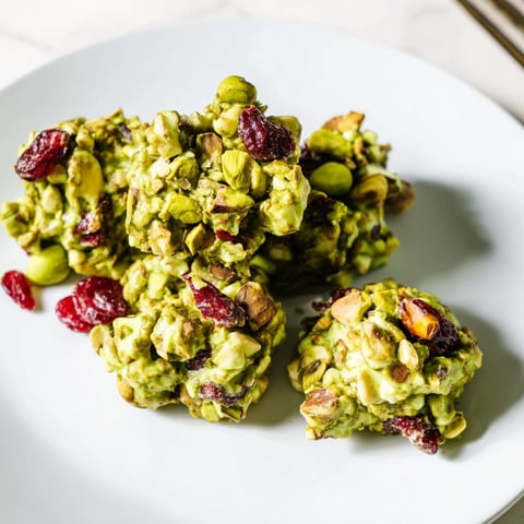 Matcha White Chocolate Cranberry Bark Clusters, a vibrant treat with visible specks of red cranberries and green tea.