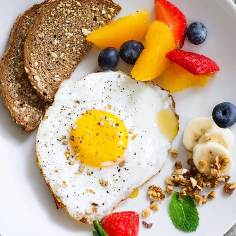 A colorful Soleil Matinal Breakfast Platter features fresh fruit, eggs, and toast, perfectly starting your day.