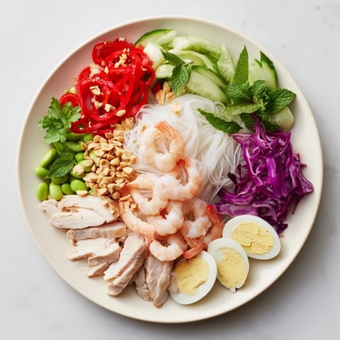 Vibrant Asian fusion noodle bowl featuring colorful vegetables, proteins, and dipping sauces displayed beautifully.
