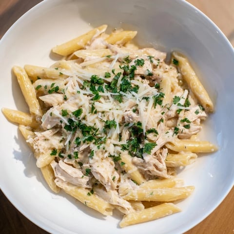 Creamy Tinis Chicken Pasta, a warm, inviting bowl with tender chicken and cheesy, glossy sauce.