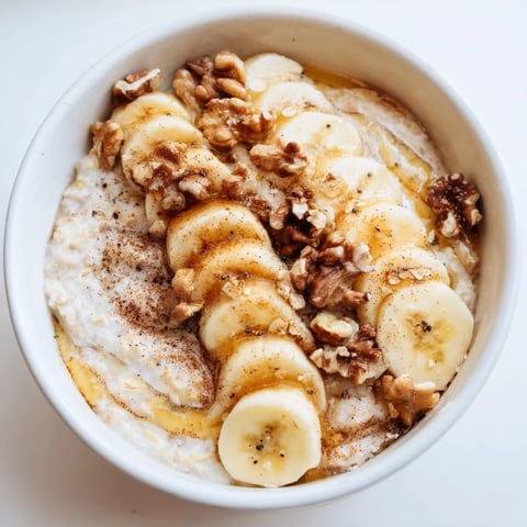 Creamy microwave banana oats, garnished with banana slices, ready for a warm and quick breakfast.