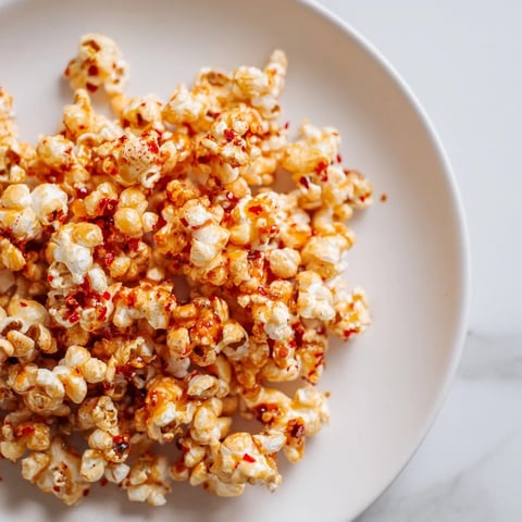 Golden, glistening Hot Honey Butter Popcorn with a perfect sweet and spicy balanced flavor.