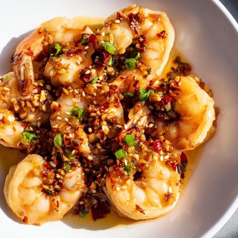 Korean Garlic Butter Shrimp sizzling in a skillet, coated in a luscious, gochugaru-infused sauce.