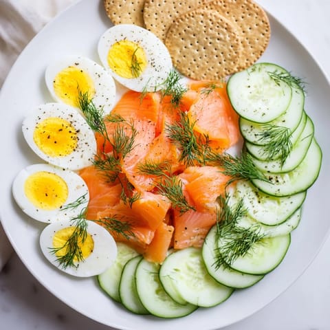 Picture a Smoked Salmon &amp; Cucumber Breakfast Plate sprinkled with fresh dill, ready to eat.