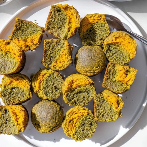 Vibrant matcha pumpkin muffin butter bites topped with powdered sugar for added sweetness.  