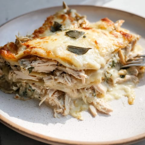 Comforting rosemary chicken lasagna served warm, perfect for family gatherings.  