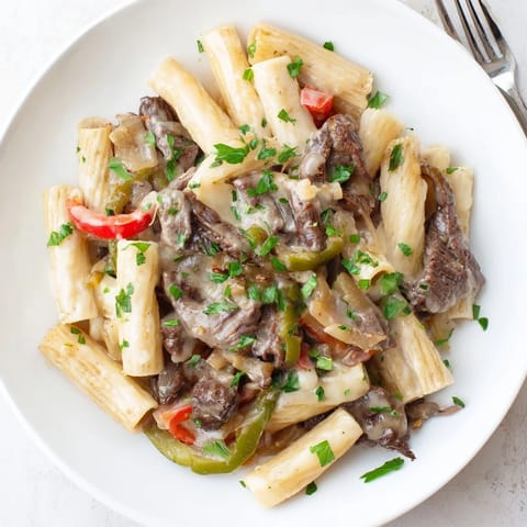 Hearty Philly cheese steak pasta served warm, bursting with flavor and textures.  