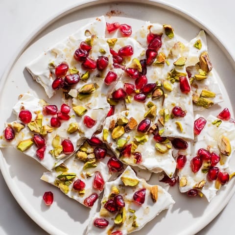 This frozen yogurt bark showcases pieces of creamy yogurt topped with ruby-red pomegranate and green pistachios.