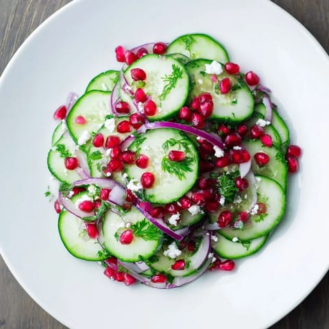 Festive Healthy Cucumber Christmas Salad ready to serve, tossed with a zesty citrus dressing.