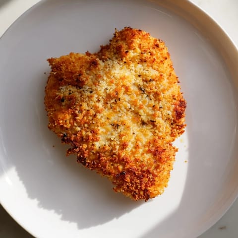 Juicy Air Fryer Chicken Cutlets, coated in a seasoned, crunchy breading, ready to be devoured with sauce.