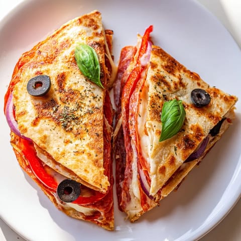 Golden-brown crispy Tortilla Pizza Wrap sizzling in a skillet, topped with melted mozzarella, pepperoni, and vibrant red bell peppers for a quick weeknight meal.  