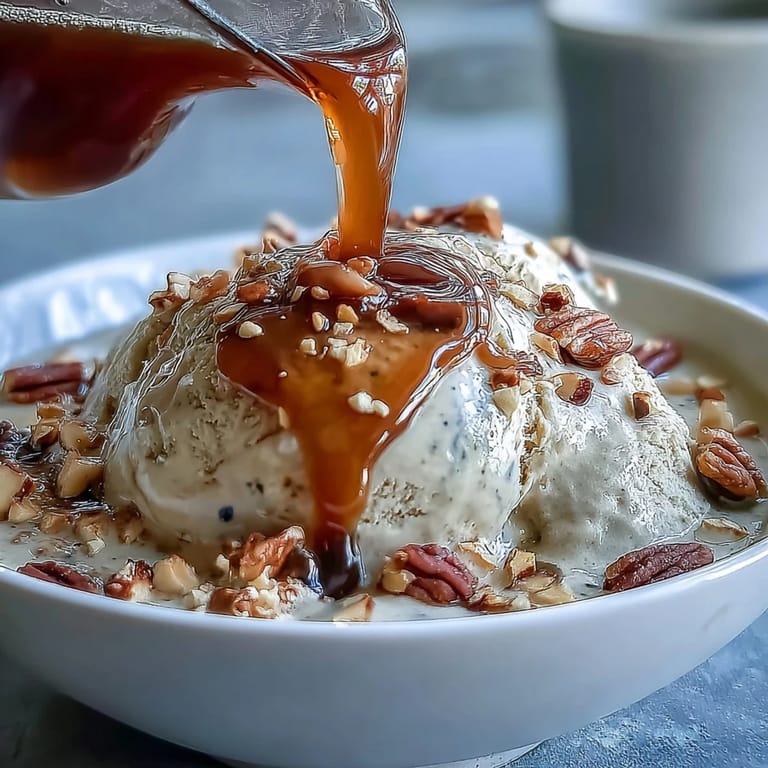 Creamy vanilla ice cream topped with hot hojicha tea and sesame seeds.